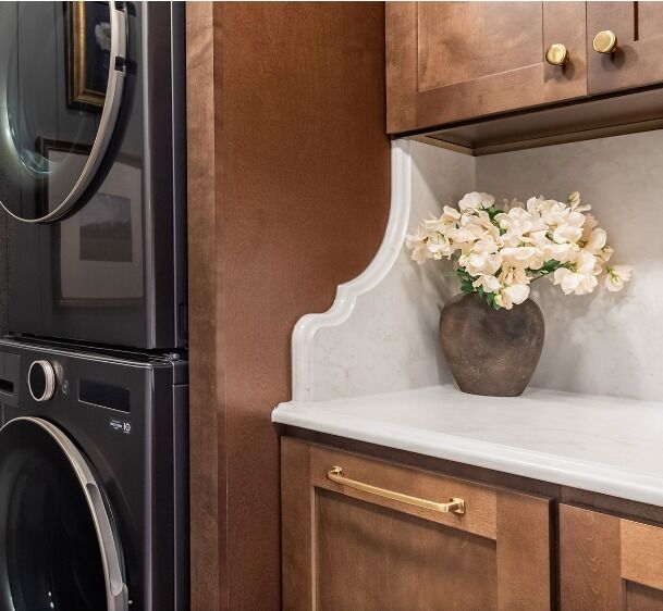 Laundry room counter with a shaped stone backsplash